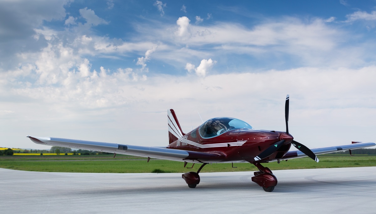 Bristell B23 maroon on ramp with blue sky